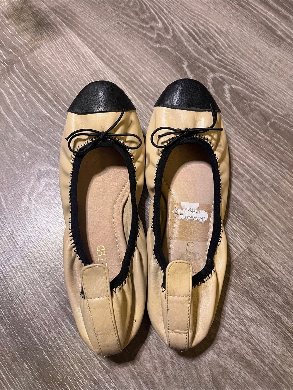 Restricted Beige and Black Cap-Toe Ballet Flats with Bow